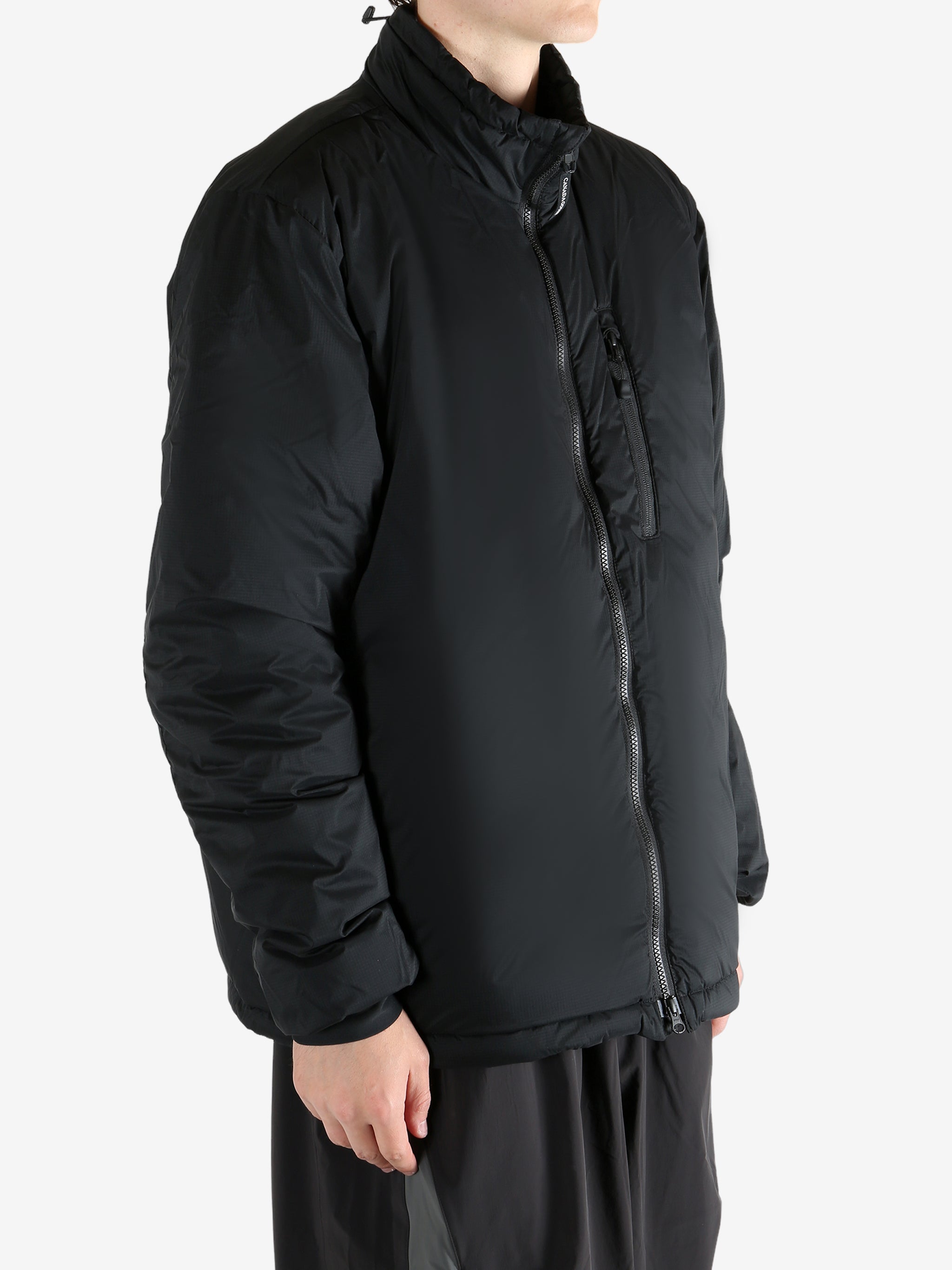 Black jacket worn by a person, showing the coat's fit