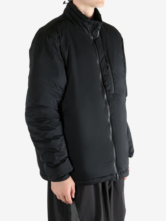 Black jacket worn by a person, showing the coat's fit