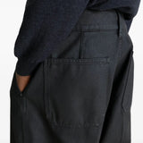 Close up of black pants, showing texture of the cotton fabric