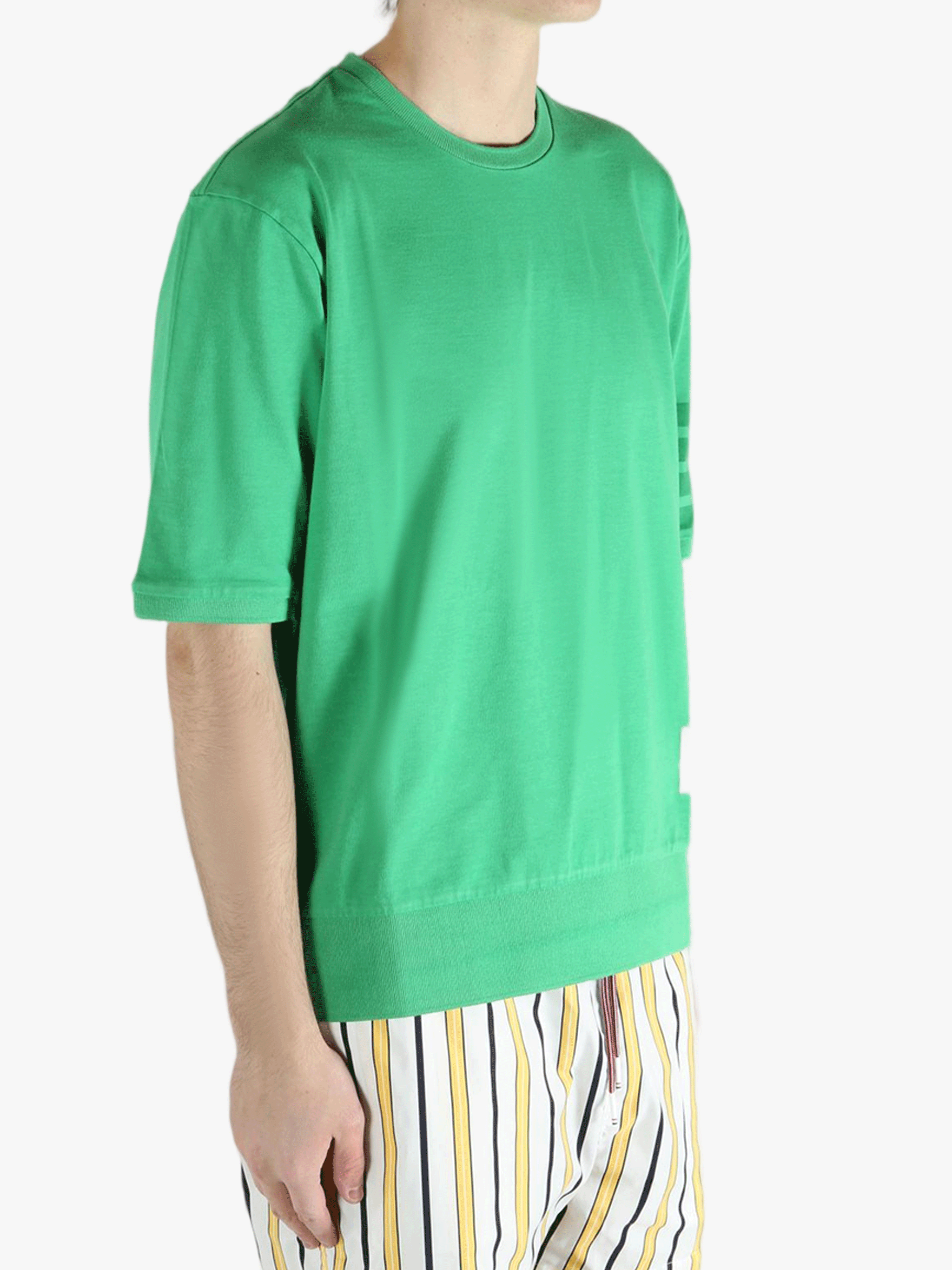 Green t-shirt worn by a person, showing the shirt's fit