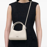 White bag worn by a person, showing the bag's fit