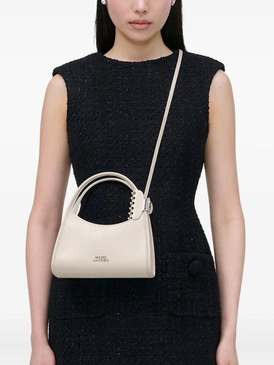 White bag worn by a person, showing the bag's fit