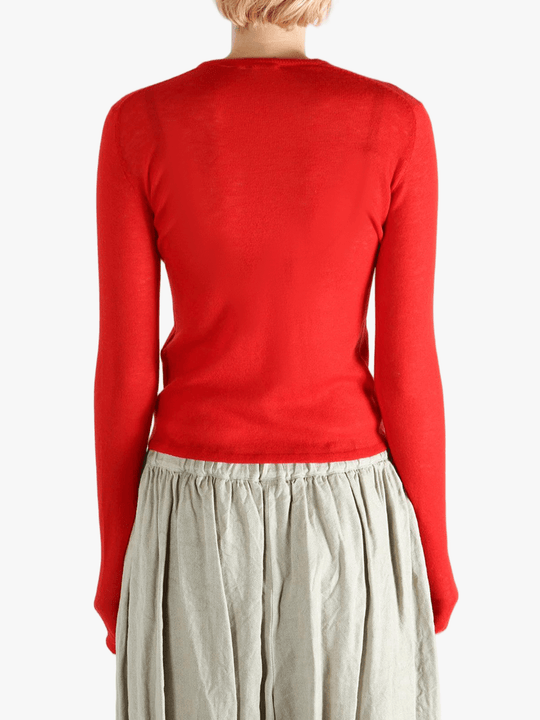 Red knitwear worn by a person, showing the knitwear's fit