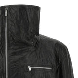 Close up of black jacket, showing texture of the leather fabric