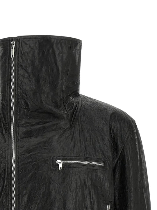 Close up of black jacket, showing texture of the leather fabric
