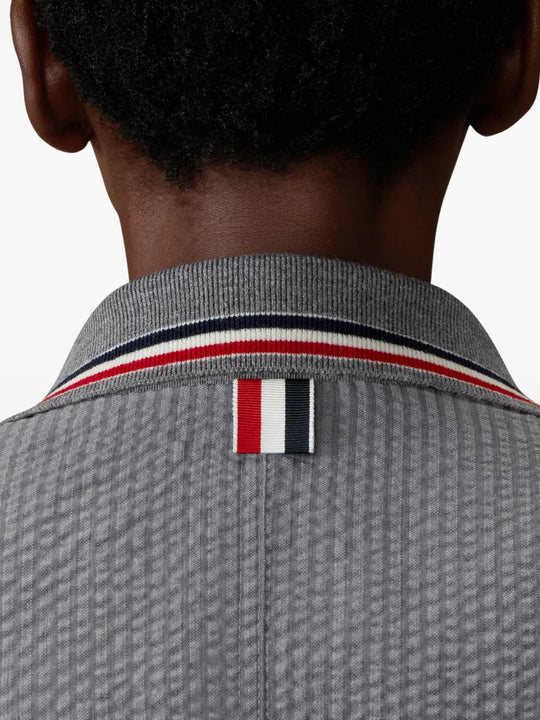 Grey jacket worn by a person, showing the jacket fit