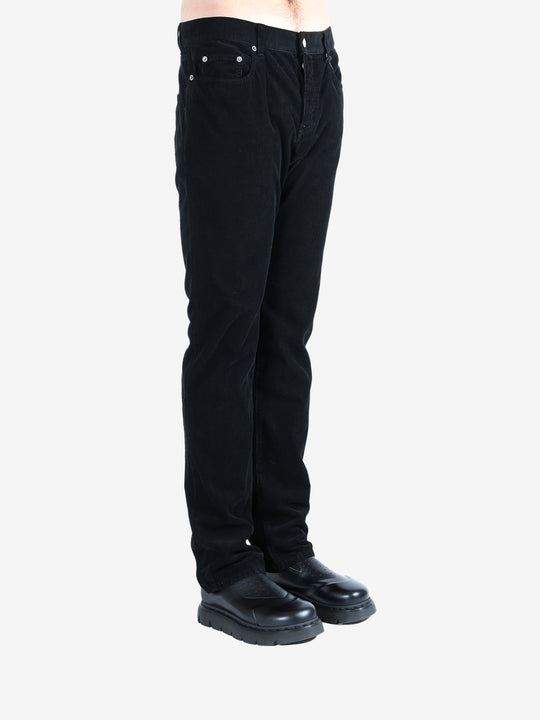 Black pants worn by a person, showing the pants's fit