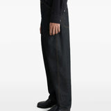 Navy pants worn by a person, showing the pants' fit