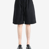 Black short worn by a person, showing the short's fit