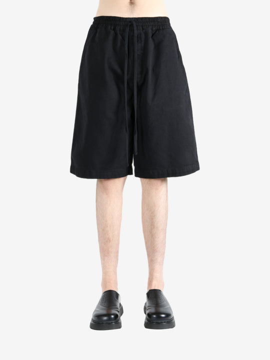 Black short worn by a person, showing the short's fit