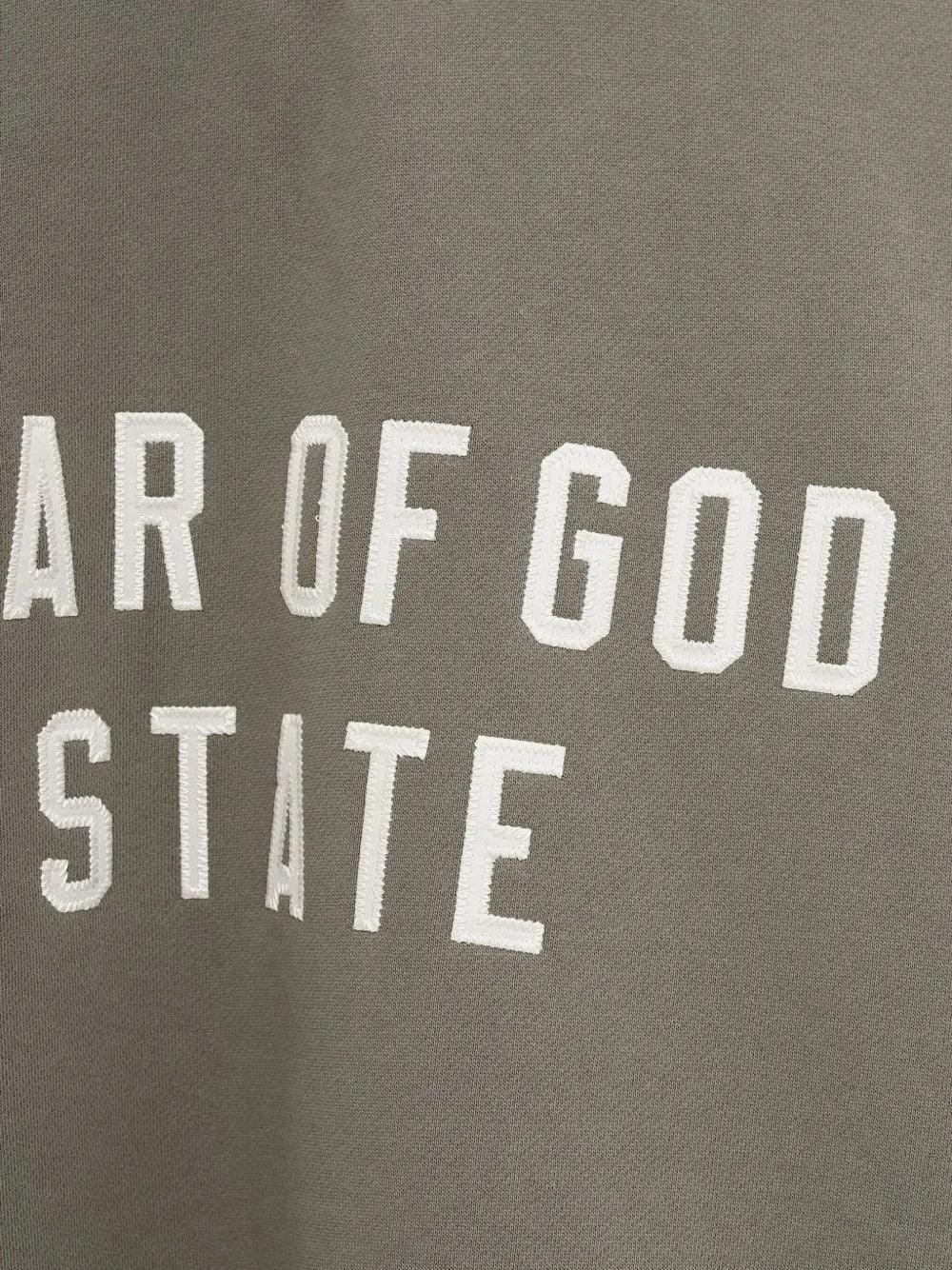 Close up of the green sweatshirt, showing texture of the cotton fabric