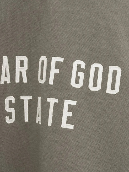 Close up of the green sweatshirt, showing texture of the cotton fabric