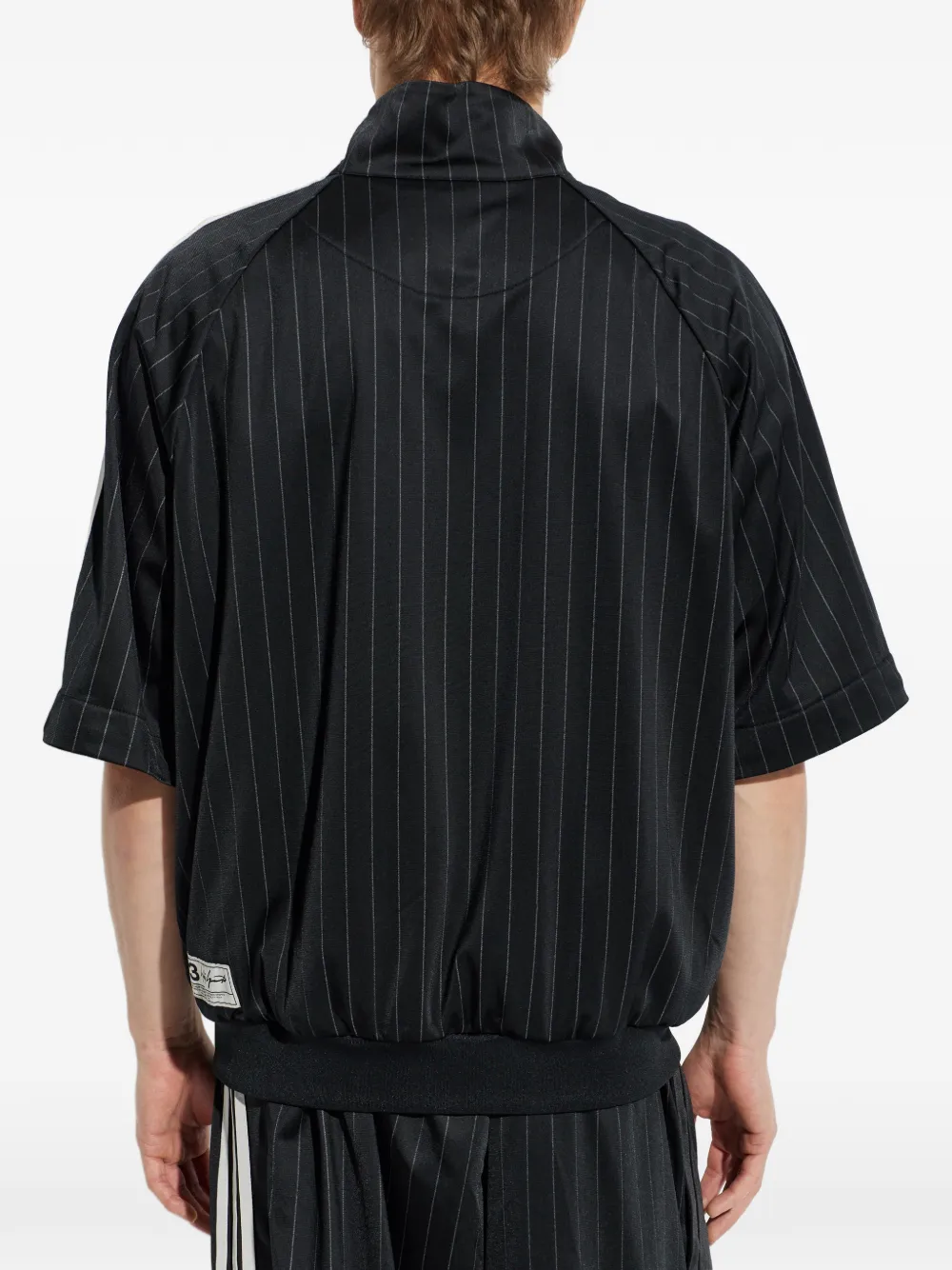 black jackets-coats worn by a person, showing the  jackets-coats fit