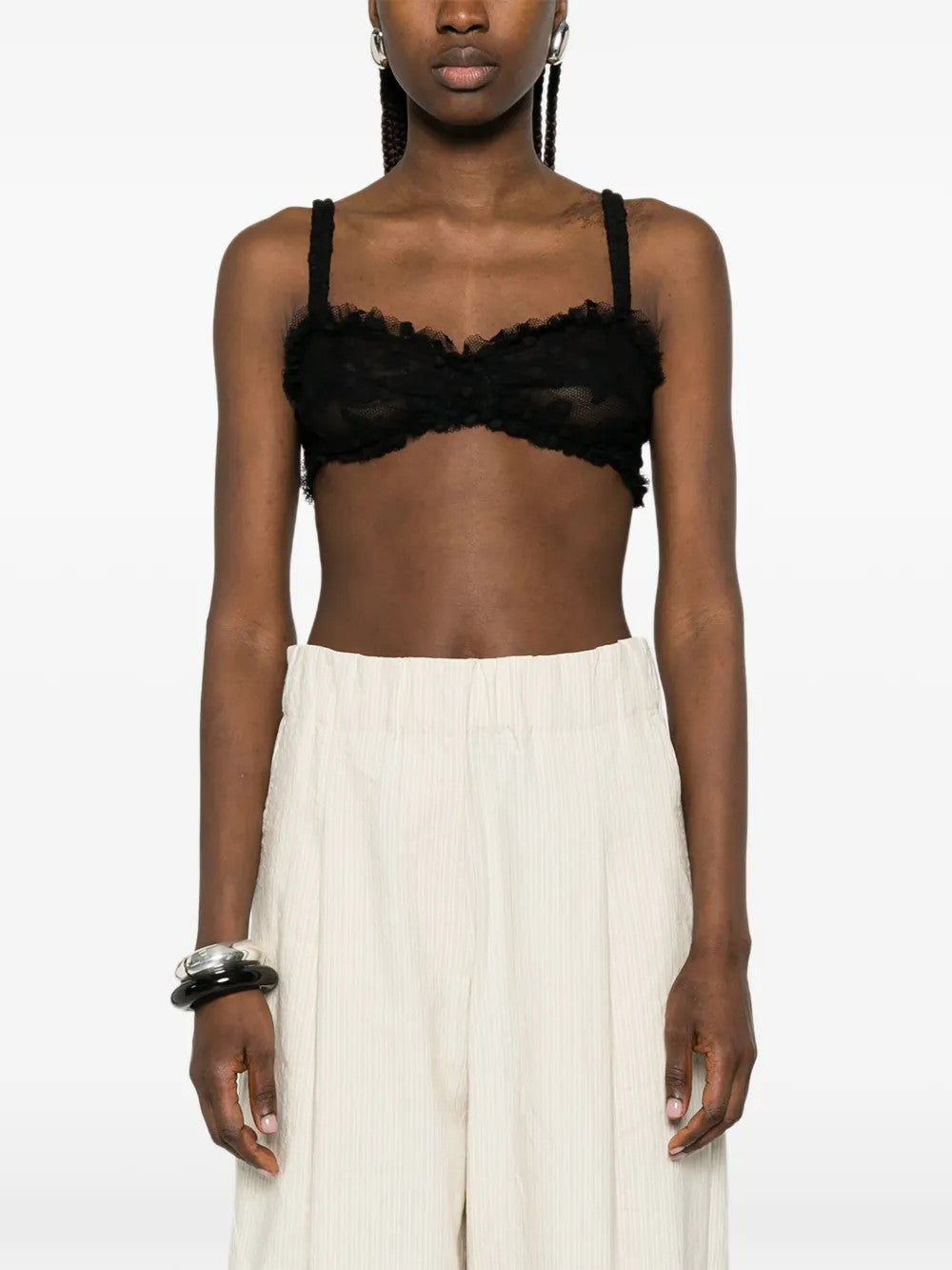 Black top worn by a person, showing the top fit