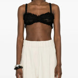 Black top worn by a person, showing the top fit