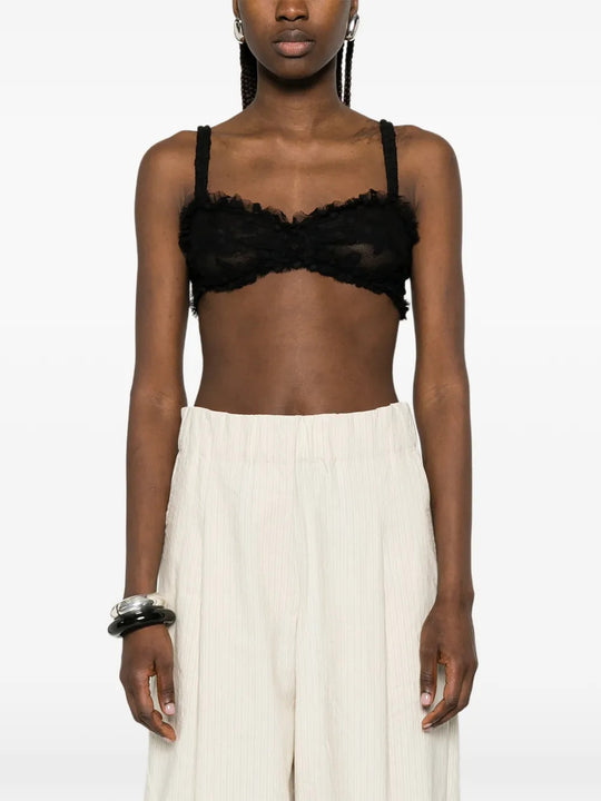Black top worn by a person, showing the top fit