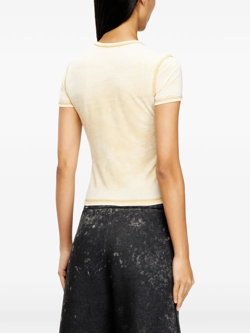 yellow top worn by a person, showing the top fit