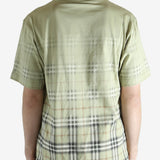 green t-shirt worn by a person, showing the t-shirt fit