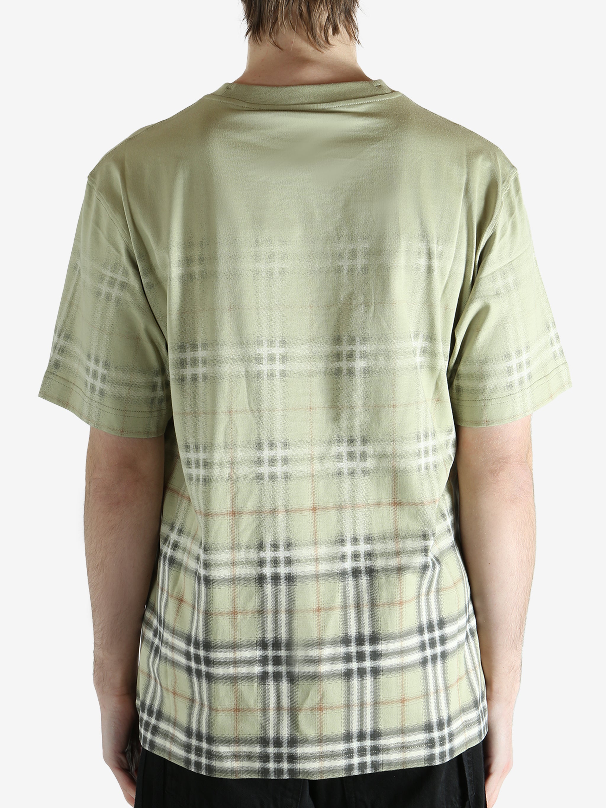 green t-shirt worn by a person, showing the t-shirt fit