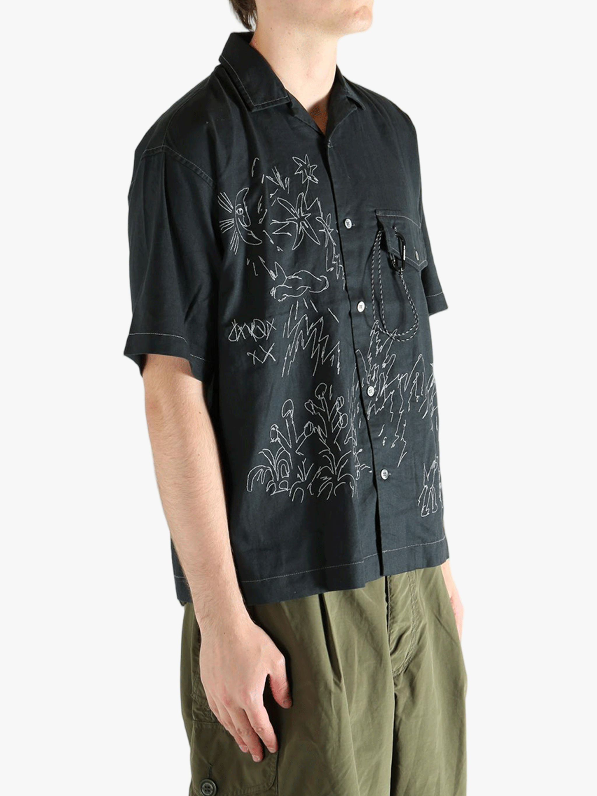 Black shirts worn by a person, showing the shirts fit