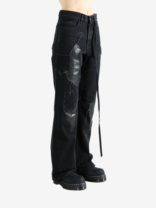 Black pants worn by a person, showing the pants' fit