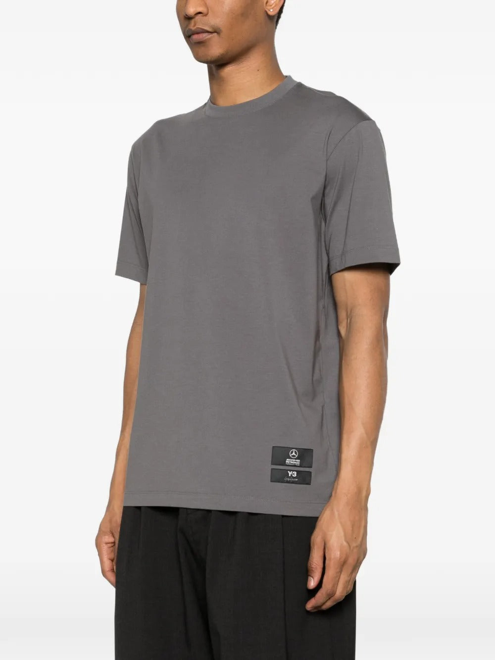 Grey t-shirt worn by a person, showing the shirt's fit