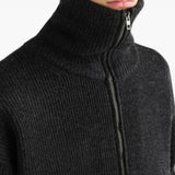 Black knitwear worn by a person, showing the knitwear fit
