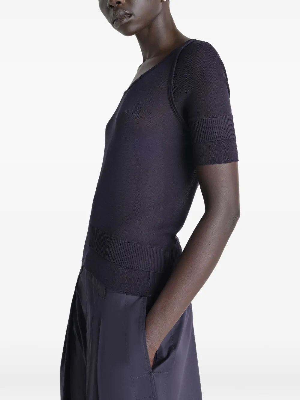 Black top worn by a person, showing the top's fit