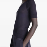 Black top worn by a person, showing the top's fit