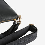 Close up of black bag, showing texture of the leather fabric