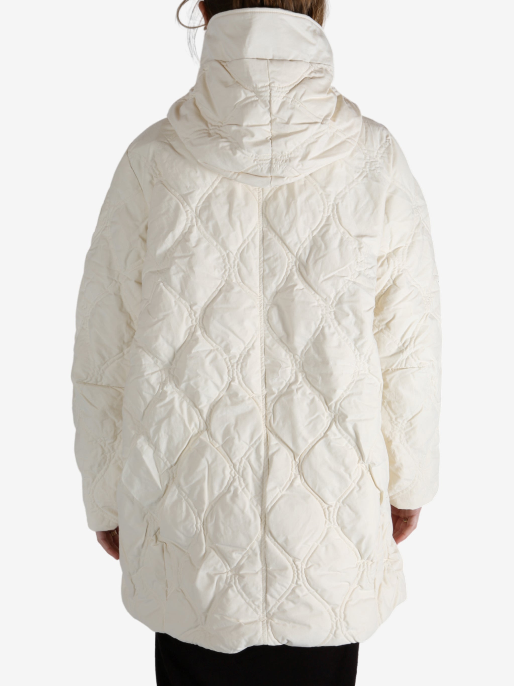 White coat worn by a person, showing the coat fit