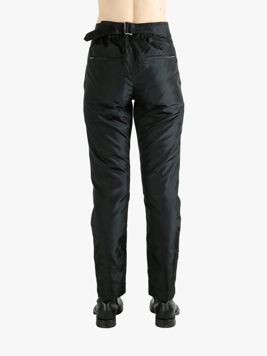 Black pants worn by a person, showing the pants' fit