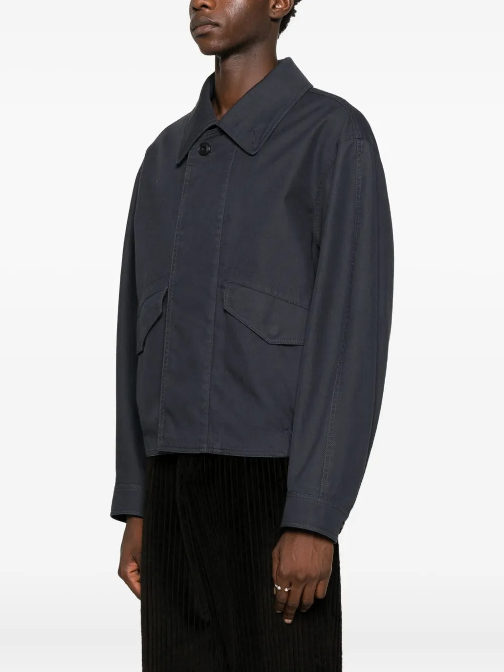 Black coat worn by a person, showing the jacket's fit