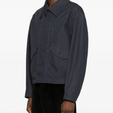 Black coat worn by a person, showing the jacket's fit