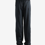 Black pants worn by a person, showing the pants' fit