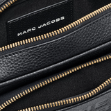 Close up of black bag, showing texture of the leather fabric
