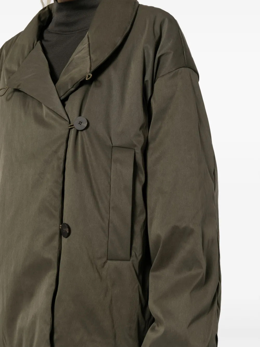 Green jacket worn by a person, showing the jacket fit