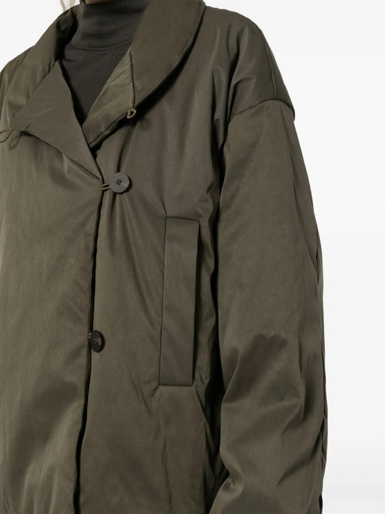 Green jacket worn by a person, showing the jacket fit