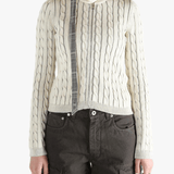 White knit long sleeve worn by a person, showing the loose fit.