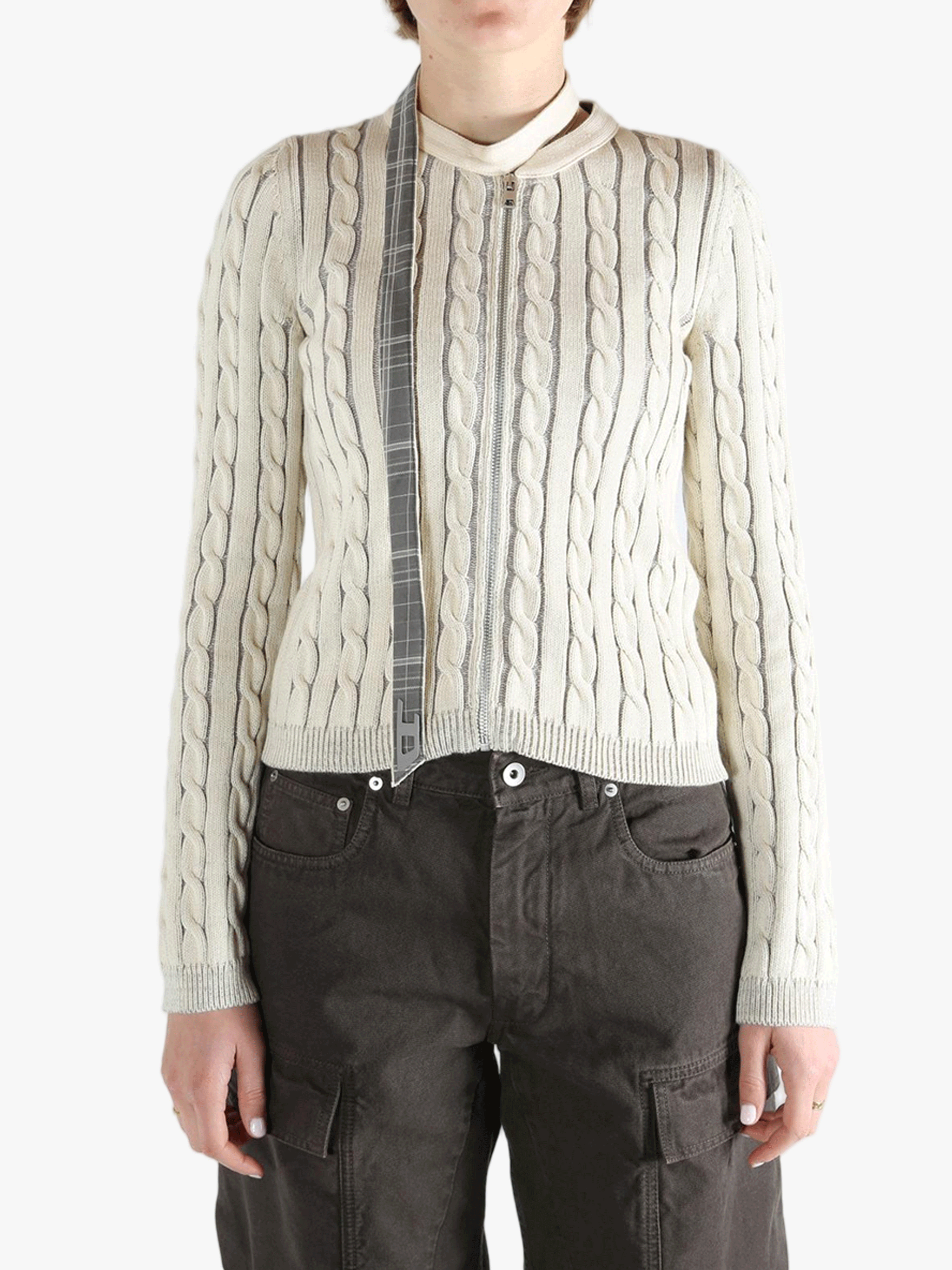 White knit long sleeve worn by a person, showing the loose fit.