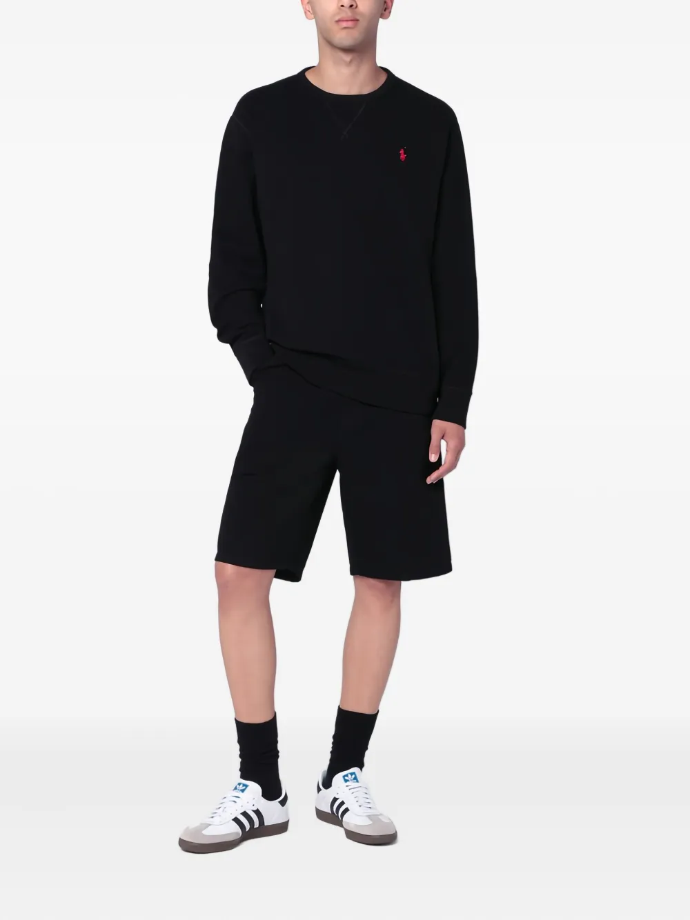 Black sweatershirt worn by a person, showing the sweatershirt's fit