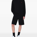 Black sweatershirt worn by a person, showing the sweatershirt's fit