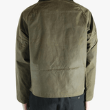 Green jacket worn by a person, showing the jacket fit