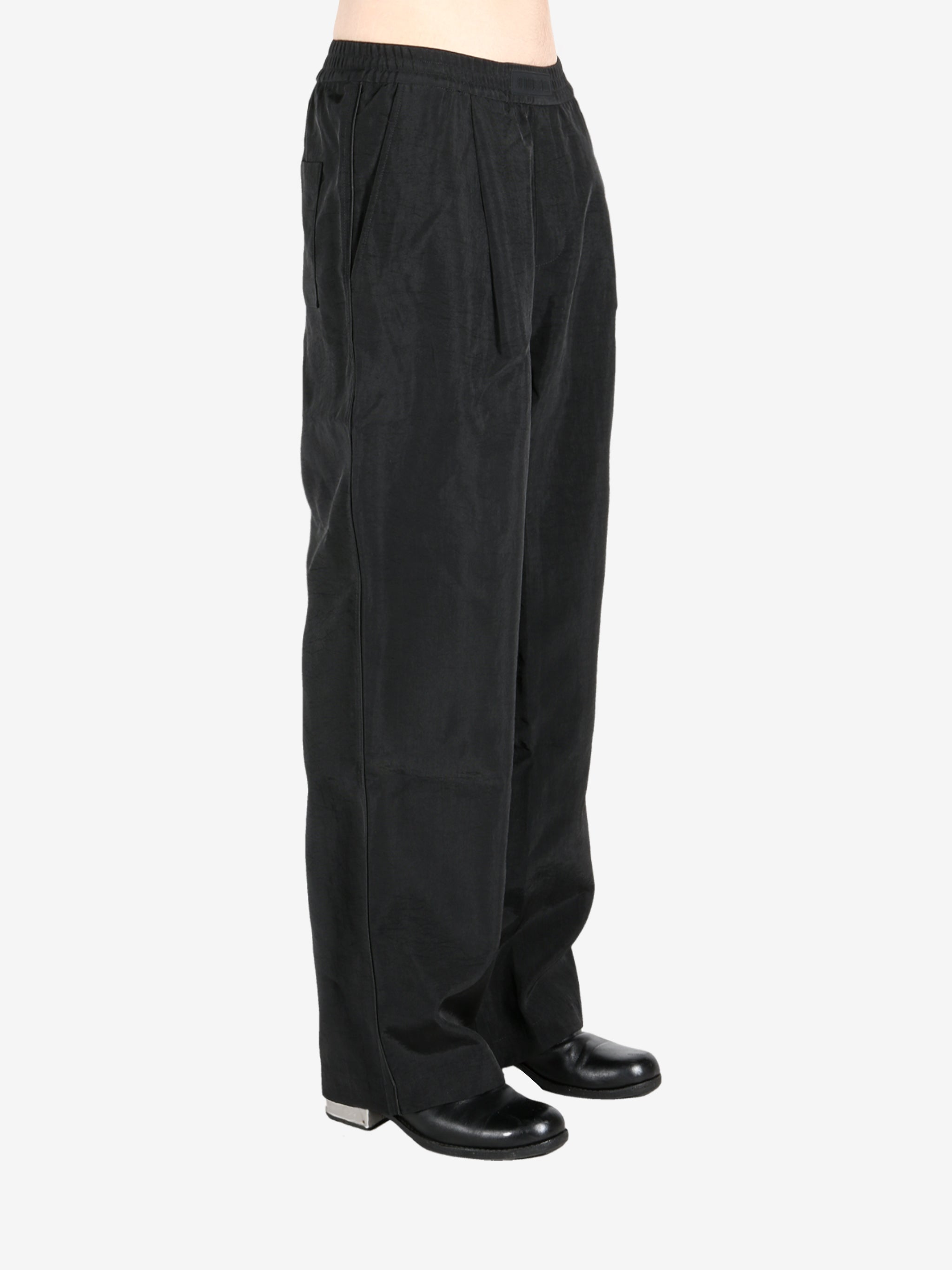 Black pant worn by a person, showing the pant’s fit