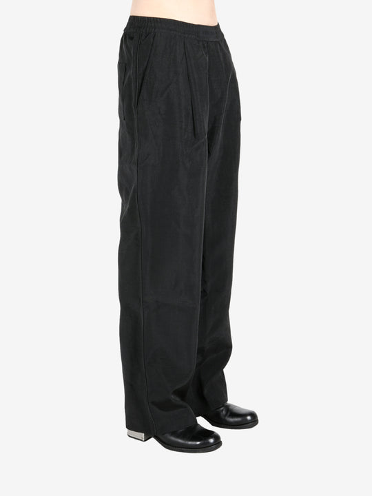 Black pant worn by a person, showing the pant’s fit