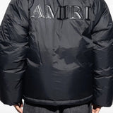 Black jacket worn by a person, showing the jacket's fit