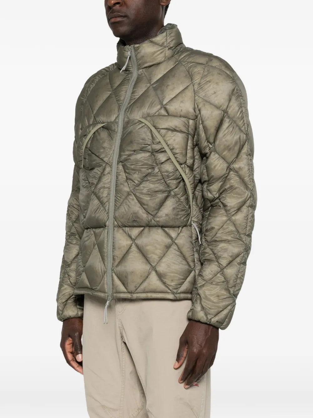 Green jacket worn by a person, showing the jacket fit