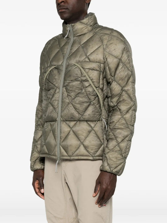 Green jacket worn by a person, showing the jacket fit