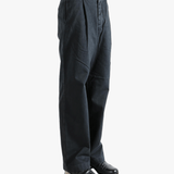 Black pants worn by a person, showing the pants fit