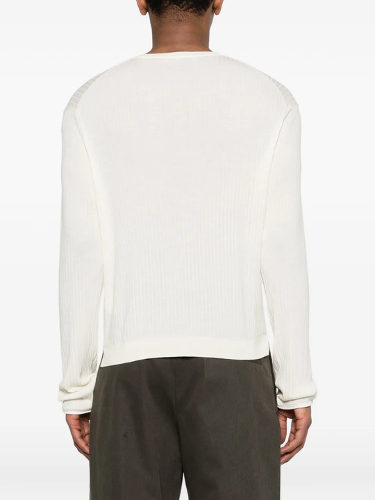White knitwear worn by a person, showing the knitwear fit